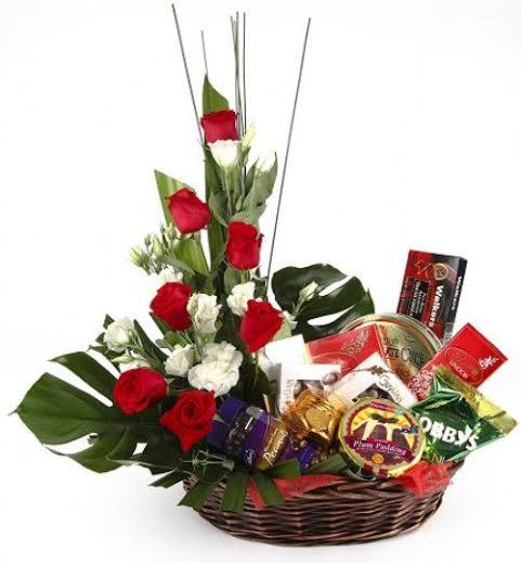 Basket arrangement of roses and 10 assorted bars of chocolates product311